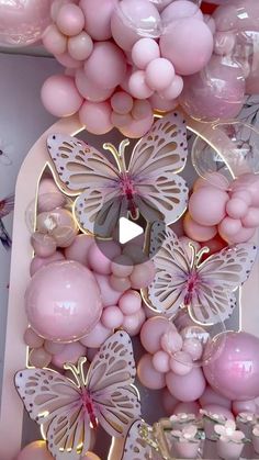 a bunch of balloons that are in the shape of butterfly's and butterflies on a wall