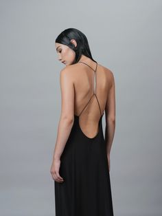 AN OPEN BACK DRESS, FEATURING A SCULPTURAL BIOMORPHIC SPINE METAL TRIM, ACCENTUATES THE BEAUTY OF THE HUMAN FORM. HIGH STRETCH AND COMFORT-FEEL JERSEY. MAXI LENGTH. STYLED WITH: BUTT BAG MESH HAND BAG HUMAN MESH BAG STRETCH JERSEY GRACE LING SIGNATURE LOGO ENGRAVED SHIPS IMMEDIATELY SHIPS WORLDWIDE Chain Open Back Dress, Luxury Backless Maxi Dress With Lace-up Back, Luxury Backless Dress With Lace-up Back, Sling Back Dress, Black Dress Cross Back, Nacked Back Dress Pattern, Elegant Black Maxi Dress With Strappy Back, Black Low Back Maxi Dress For Evening, Black Low-back Maxi Dress For Evening