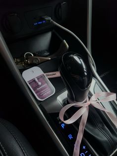 the interior of a car with an air freshener and hair dryer in it