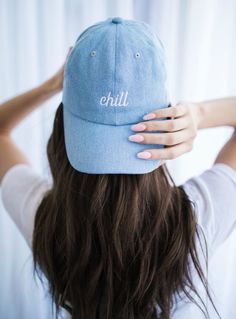 a woman wearing a blue hat with the word chill on it's front and back