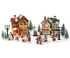 a group of christmas village figurines sitting next to each other