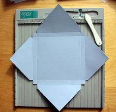 the cutting board is being used to cut out paper for an origami kite