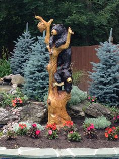 a statue of a bear sitting on top of a tree stump next to a pool