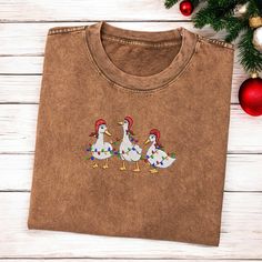 Embroidered Ducks Santa Christmas Light Shirt Christmas Ducks Shirt Christmas Crewneck Women Xmas Ducks Shirt Winter Shirt Ugly Christmas  DESCRIPTION If you want to add or change anything on the existing design shown in the display picture, please contact the seller through the message box to inquire if the changes and additional requests can be accommodated. If you do not inquire and request changes in your order without prior approval, we will ship the item as is without the requested modific Casual Embroidered Christmas Top, Embroidered Christmas Holiday Tops, Holiday Embroidered Tops As Gift, Duck Christmas, Embroidered Duck, Christmas Duck, Duck Shirt, Christmas Crewneck, Winter Shirts