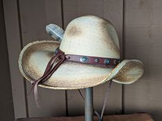 The Cassidy starts with a soft palm hat body that has been flame distressed so it looks like it has already been broken in. The brim is approximately 4" and the crown is 5". There is a wire in the brim so you can shape it however you want. The leather hatband is new rein leather and has lots of Southwestern Conchos. The back of the band has a deer antler bead for accent. Stampede strings are attached to hat which will make it a great hat for riding or on those windy days. Finished with an Owl fe Adjustable Costume Hats With Short Brim For Western Events, Adjustable Costume Hat For Western-themed Events, Adjustable Wide Brim Costume Hats For Western-themed Events, Adjustable Costume Hat With Curved Brim For Western-themed Events, Western Costume Hat With Adjustable Curved Brim, Adjustable Wide Brim Costume Hats For Country Events, Adjustable Distressed Hats For Country Events, Distressed Adjustable Hats For Country Events, Adjustable Distressed Brimmed Hat