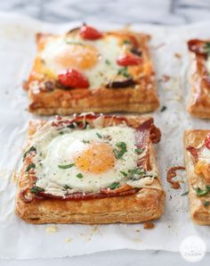 four square pieces of bread with eggs on them