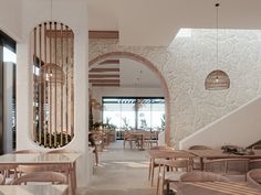 the inside of a restaurant with wooden tables and chairs