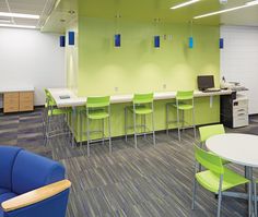 an office with chairs, desks and computers