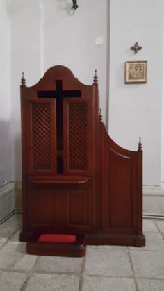 a wooden bed with a cross on the headboard