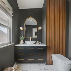 a bathroom with a sink, mirror and toilet in it's centerpieces