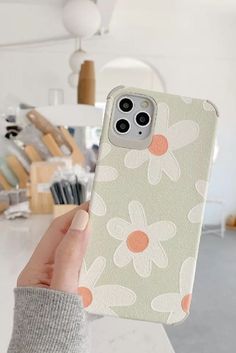 a person holding up an iphone case with flowers on it