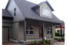 a gray house with two car garages on each side