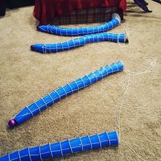 two blue pipes are laying on the floor