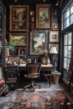 a room with many paintings on the wall and a desk in front of a window