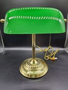 a green lamp sitting on top of a table