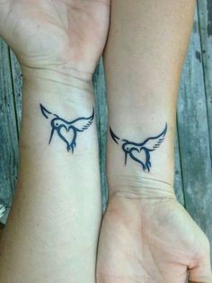 two people with matching tattoos on their wrist