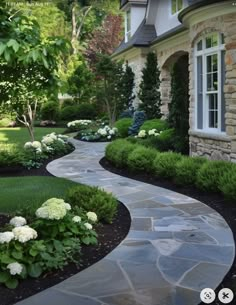 a stone walkway leading to a house with white hydrangeas and green bushes on either side