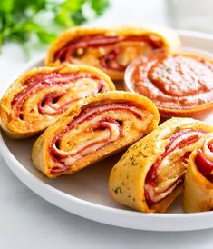 several pastries on a plate with sauces and parsley in the back ground