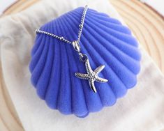 Our stunning Sea Star Silver Necklace effortlessly combines elegance with a touch of the ocean.🌟 The high quality silver stainless steel chain is adorned with a Sea Star pendant that brings a touch of coastal charm, making it a statement piece for any occasion. The Sea Star or Starfish is a symbol of resilience, regeneration, and the beauty of the ocean. With intricate detailing and a shiny silver hue, this pendant adds a touch of coastal charm to any outfit. Add this cute Sea Star Gold Necklace now to your jewelry collection. ▼  Stainless Steel  ▼ Length: 45 cm with extend option to 50 cm. ▼ Sea Star pendant is approx. 2 cm 🚩  Please try to keep this jewelry away from make up, shower gel, crème, lotions, perfume etc. to keep it in great quality and long lasting 🌊 *Follow SEABYLOU on In Ocean-inspired Silver Charm Necklace With Lobster Clasp, Ocean-inspired Silver Necklaces With Charms, Ocean-inspired Silver Necklace With Star Charm, Adjustable Silver Starfish Necklace, Silver Adjustable Starfish Necklace, Star Silver, Star Necklace Silver, Coastal Charm, Seashell Art