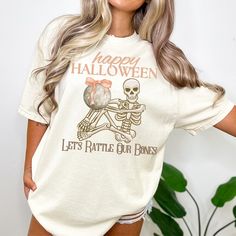 THANK YOU FOR SHOPPING WITH US🤍🤍🤍🤍 Get ready to put a spooky and stylish spin on Halloween with our women's skeleton disco ball themed t shirt! This unique and eye-catching design features a dancing skeleton holding up a disco ball with the words "Happy Halloween Let's Rattle Our Bones." The perfect combination of creepy and cool. Made from high quality comfort colors t shirt material, this shirt is as comfortable as it is festive. The relaxed fit and soft material make it the perfect choice Groovy Halloween, Women Skeleton, Dancing Skeleton, Halloween Top, Skeleton Halloween, Halloween Looks, Unique Shirt, Retro Halloween, Halloween T Shirt