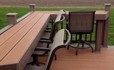 two chairs sitting on top of a wooden deck next to a table and chair set