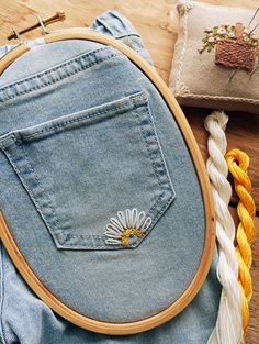 a close up of a piece of cloth with a embroidery on it and some other items