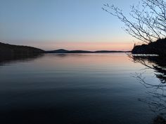 the water is calm and clear at sunset