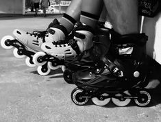 black and white photograph of three roller skates with one being on the other side