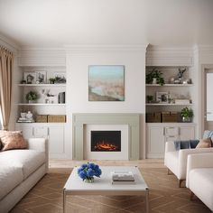 a living room with two couches and a fire place in it's center