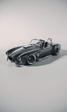 an old fashioned sports car is shown in this black and white photo