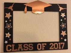 a black and gold class of 2017 photo frame with a graduation cap on the top