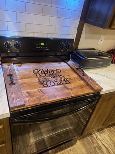 a wooden cutting board sitting on top of an oven