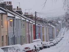 a row of colorful houses covered in snow