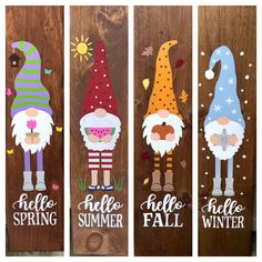 three wooden signs with gnomes and snowmen painted on them, one says hello spring the other says hello fall winter