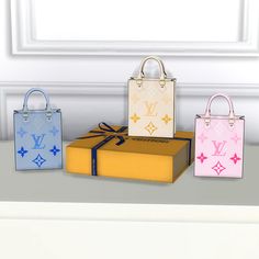 three louis vuitton bags sitting next to each other in front of a window