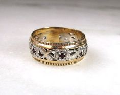 two gold wedding bands with white diamonds and garnets on the sides, set in 18k yellow gold