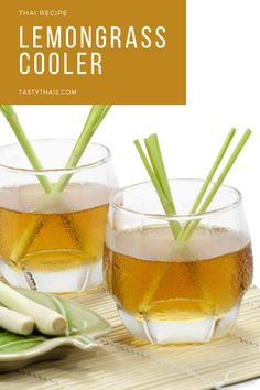 two glasses filled with lemongrass cooler sitting on top of a bamboo mat