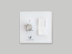 a white light switch sitting on top of a wall