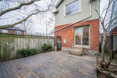 an outdoor deck with steps leading to the back door