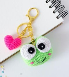 a crocheted keychain with a heart shaped object on top of it