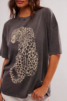 Effortlessly cool and essential, this classic tee is featured in a soft cotton fabrication and oversized fit with leopard graphic at the front and distressed detailing. **Fit:** Slouchy, oversized fit **Features:** Soft cotton fabrication, scoop-neckline, leopard graphic at front, distressed detail throughout, drop-shoulder sleeves **Why We ❤ It:** This timeless tee is sure to become a go-to in any wardrobe. | Leopard Tee by Promesa at Free People in Grey, Size: M