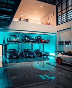 there are many cars on the shelves in this garage, and one car is blue