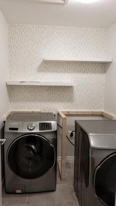 a washer and dryer in a small room with no doors on the walls