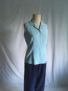 "vintage 1990s blouse label- City Silk light blue button up open double breast collar sleeveless good vintage condition, light wear no size tga, see below measures, lying flat, shoulder-12 1/2\" chest-19\" natural waist-17\" hem-20\" total length from top of collar-25\"" Fitted Light Blue Summer Shirt, Fitted Light Blue Shirt For Summer, Light Blue Fitted Summer Shirt, Blue Spread Collar Blouse For Summer, Fitted Sleeveless Light Blue Blouse, Light Blue Fitted Sleeveless Blouse, Summer Blue Blouse With Spread Collar, Classic Sleeveless Summer Shirt, Classic Light Blue Tops For Summer