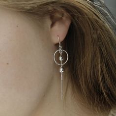 Slinky and versatile, our sterling silver orbit threader earrings are high value and hard-working. The beauty of threaders is that you can wear them solo in so many different ways, and they bring some length to an ear-stack. Martha Jackson's orbit threaders feature two polished silver balls; one in orbit and the other dangling. The threader is made from highly polished sterling silver chain. If you are looking for lightweight earrings that are comfortable and stand out, these are for you. As you'd expect from Martha Jackson, our sterling silver orbit threader earrings are made from premium recycled sterling silver. Because gifting shouldn't cost the earth. Or blow the bank. And because we want to be kind to the skin, expect hypoallergenic and nickel-free silver. All our jewellery comes wit Modern Adjustable Sterling Silver Wrap Earrings, Adjustable Hypoallergenic Sterling Silver Wrap Earrings, Adjustable Pierced Threader Earrings For Everyday, Adjustable Threader Earrings For Everyday, Silver Sterling Silver Threader Earrings, Modern Silver Threader Earrings With Ear Wire, Dainty Silver Threader Earrings, Modern Silver Long Drop Threader Earrings, White Gold Sterling Silver Threader Earrings