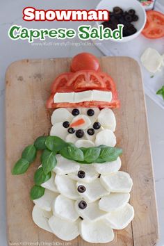 a snowman caprese salad made with mozzarella, olives and tomatoes