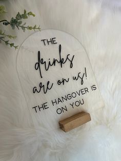 the drinks are on my hangover is on you sign next to a bottle opener