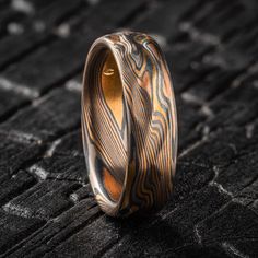 "* Price varies depending on ring sizes, we do offer half and quarter sizes, please let us know if you don't see your size as an option! This cool organic Mokume Gane band is shown in the Twist pattern and the Firestorm metal combination, with a low dome profile and an etched and oxidized finish. Our Firestorm palette features 14k red gold, 14k yellow gold, palladium, and sterling silver. The twist pattern and multicolor of the Firestorm palette bring to mind the rough and diverse terrain of the Traditional Carved Ceremonial Rings, Ceremonial Oxidized Finish Ring, Movement Pattern, Mokume Gane Ring Wedding, Mokume Gane Earrings, Mokume Gane Ring, Damascus Steel Ring, Twist Pattern, Pattern Ring