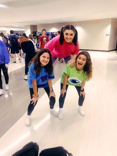 three girls are posing for the camera while bowling