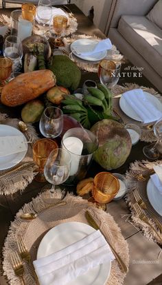 the table is set with plates, silverware and other things to eat on it